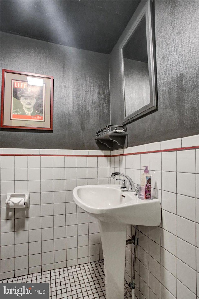 bathroom with tile walls, tasteful backsplash, and tile flooring