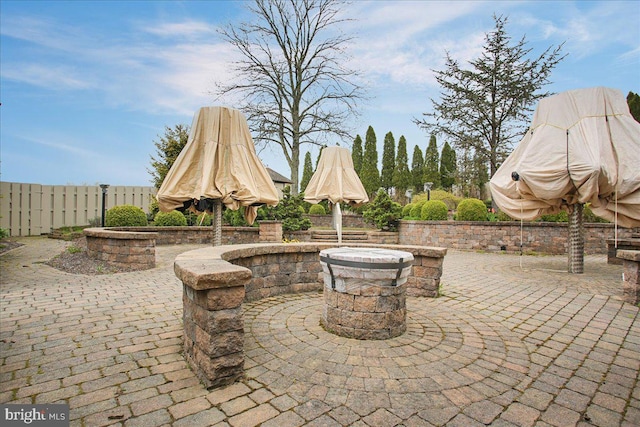 view of patio / terrace featuring an outdoor fire pit