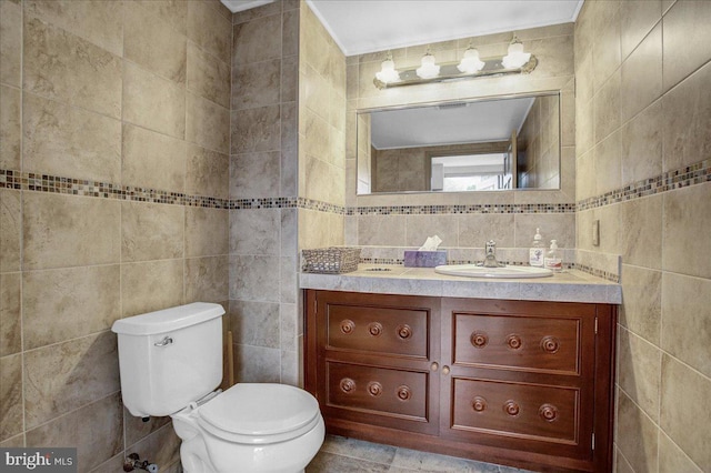 bathroom with vanity, tile walls, tile floors, toilet, and tasteful backsplash