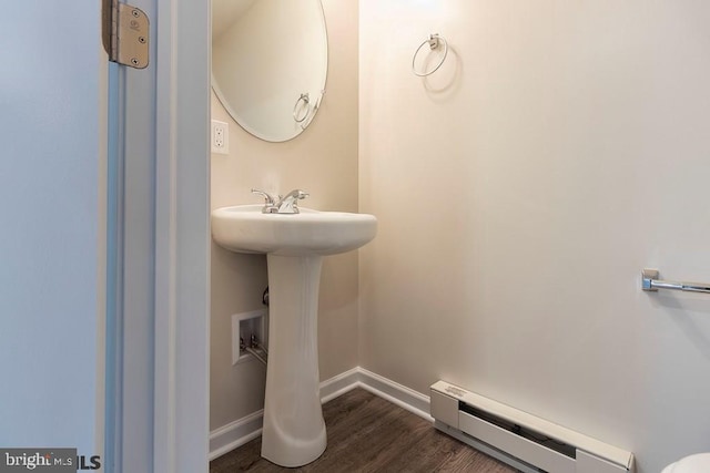 bathroom featuring hardwood / wood-style flooring and baseboard heating