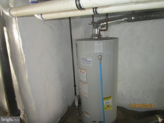 utility room featuring water heater