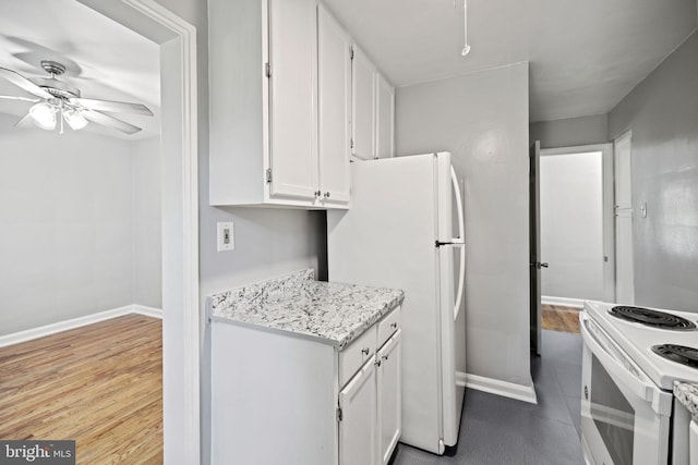 kitchen with light stone counters, light hardwood / wood-style floors, white cabinets, ceiling fan, and white appliances