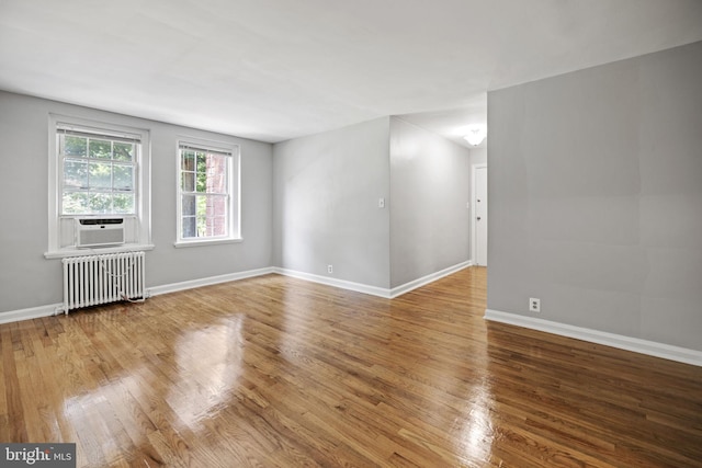 spare room with light hardwood / wood-style floors and radiator