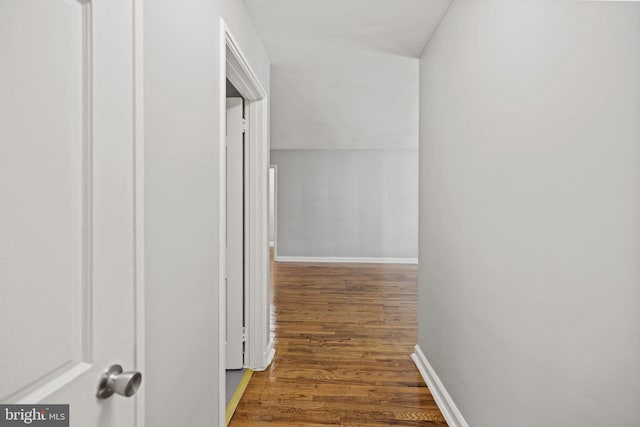 hall with dark wood-type flooring