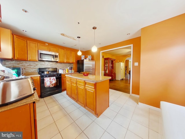 kitchen with backsplash, stainless steel appliances, light tile floors, and hanging light fixtures