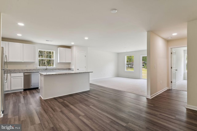 kitchen featuring white cabinets, plenty of natural light, a center island, and dishwasher