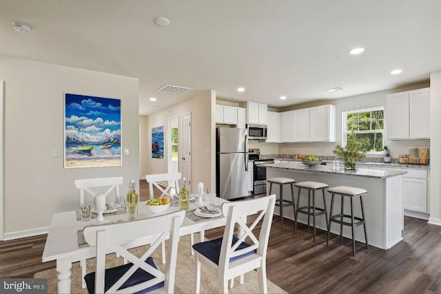 dining area with dark hardwood / wood-style flooring