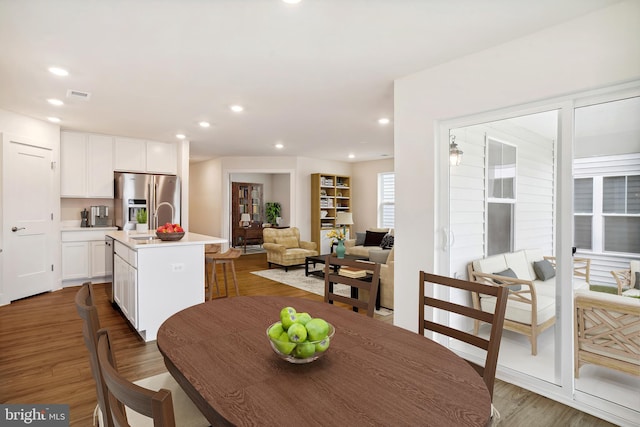 dining space with sink and hardwood / wood-style floors