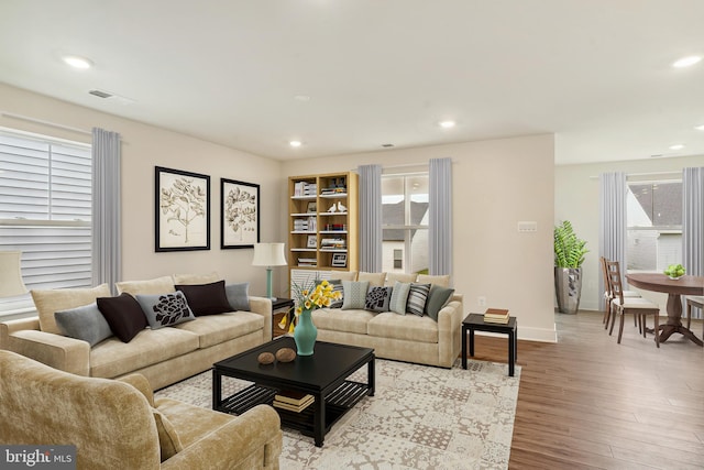 living room with a wealth of natural light and light wood-type flooring