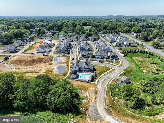 bird's eye view featuring a residential view and a wooded view