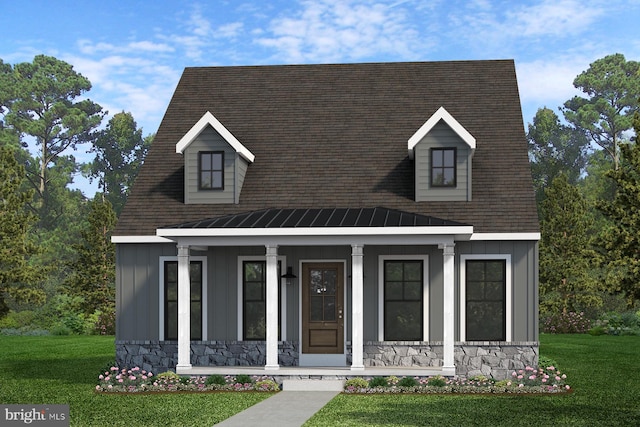 cape cod-style house with stone siding, a porch, board and batten siding, and a front yard