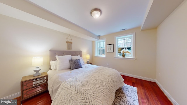 bedroom with dark wood-type flooring