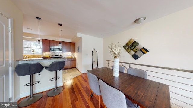 dining area featuring light wood-type flooring