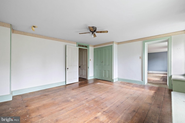 empty room featuring ceiling fan and wood-type flooring