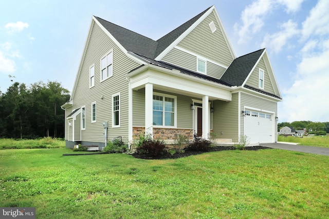 view of front of property featuring covered porch, a front lawn, and a garage