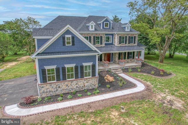 view of front of house with a front yard and a porch