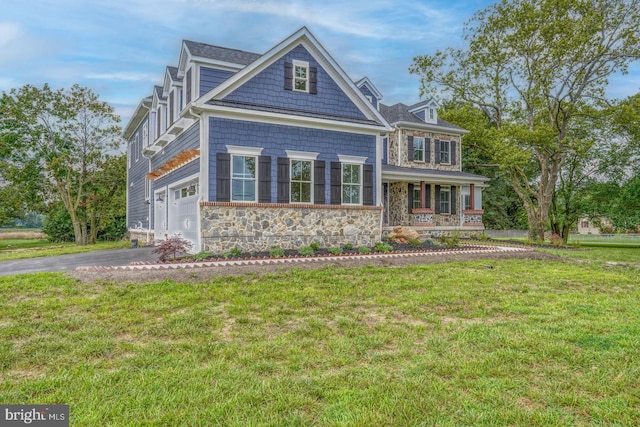 view of front of house with a front yard and a garage