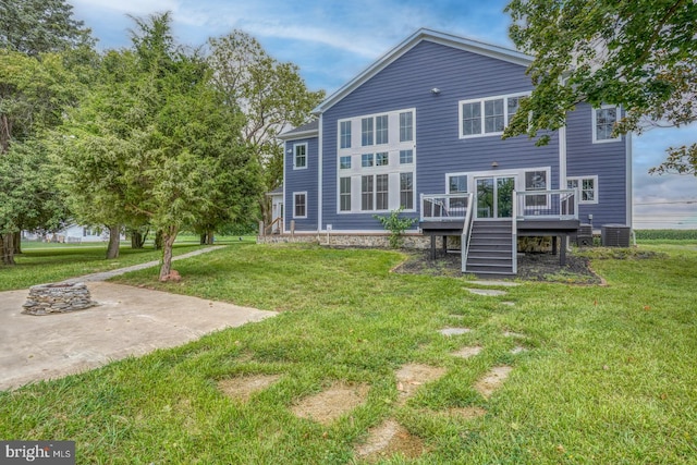 back of house with a yard, central AC, and a wooden deck