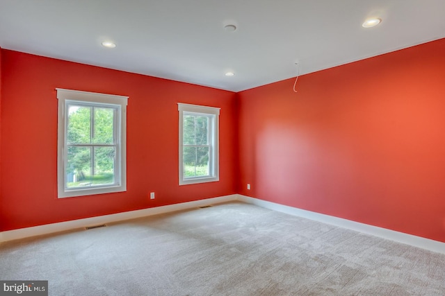 spare room with light colored carpet