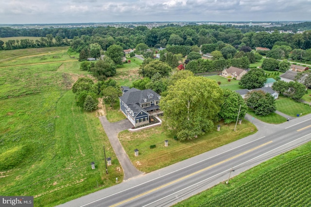 birds eye view of property with a rural view