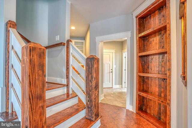 stairway with light hardwood / wood-style floors