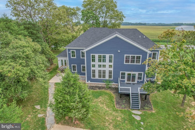 rear view of property featuring a yard