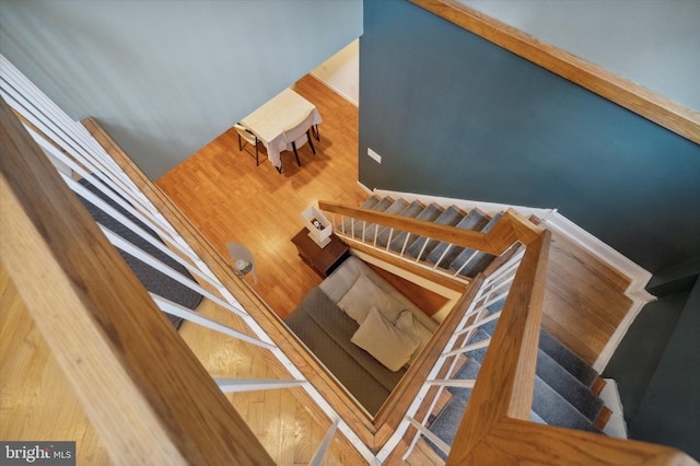 stairway featuring wood-type flooring