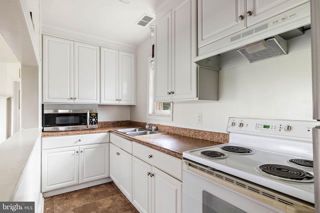 kitchen with dark tile floors, white cabinetry, sink, and white range with electric stovetop