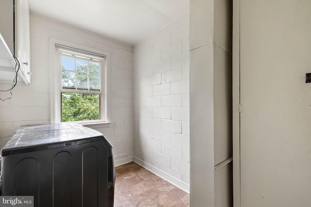 laundry room with light tile flooring and washer / dryer