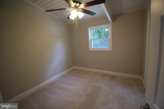 carpeted spare room featuring ceiling fan and wood ceiling