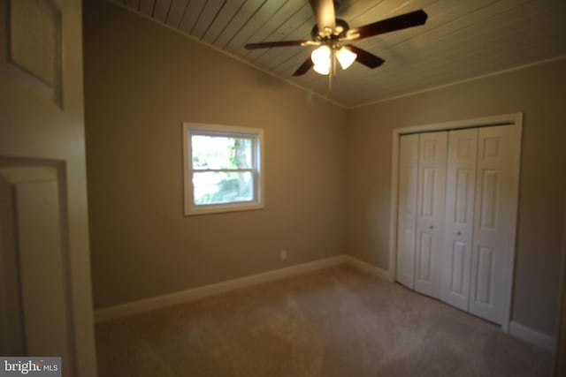 unfurnished bedroom with wooden ceiling, carpet, crown molding, a closet, and ceiling fan