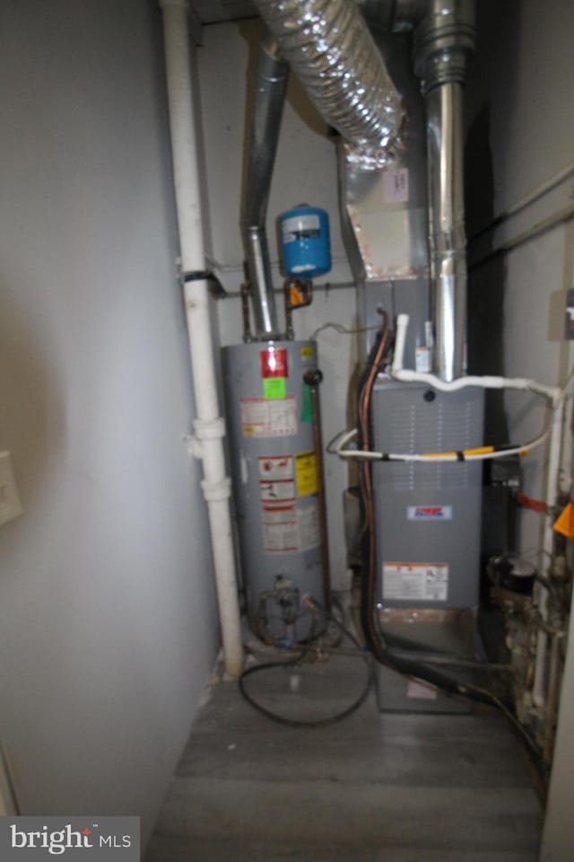 utility room with water heater