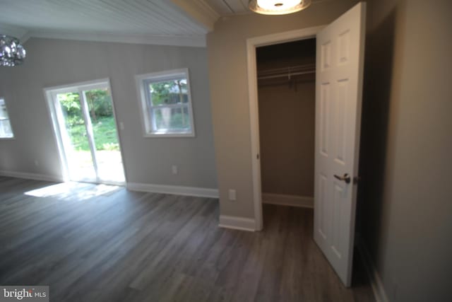 unfurnished bedroom featuring a chandelier, access to outside, ornamental molding, and dark wood-type flooring