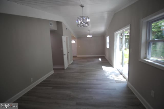 hall featuring a chandelier, lofted ceiling, and dark hardwood / wood-style flooring