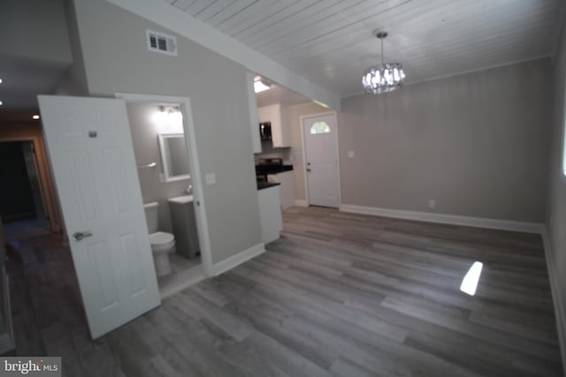 foyer with dark hardwood / wood-style flooring and a notable chandelier