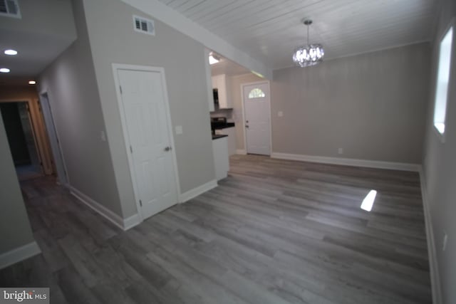 interior space featuring an inviting chandelier and dark hardwood / wood-style flooring