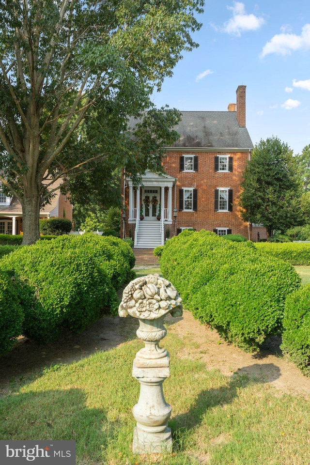 colonial inspired home with a front yard