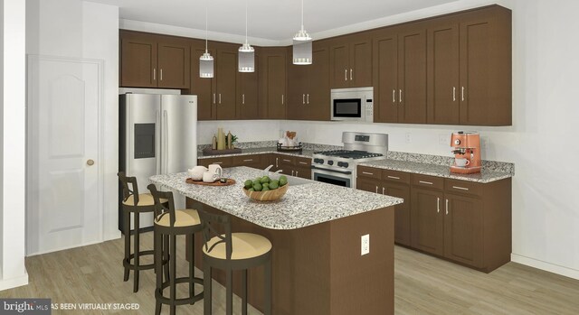 kitchen with pendant lighting, dark brown cabinets, stainless steel appliances, and a center island