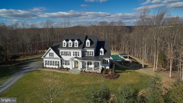 view of front of home with covered porch and a front lawn