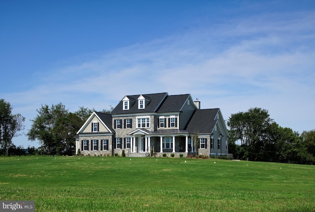 view of front of home with a front yard and covered porch