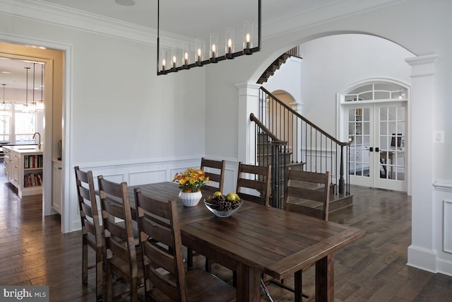 dining space featuring ornamental molding, dark hardwood / wood-style flooring, and french doors