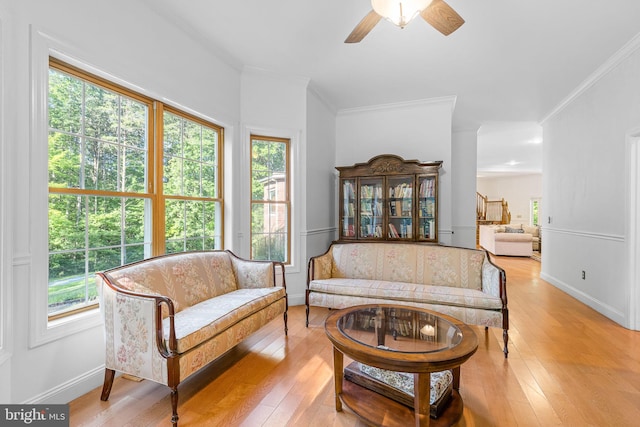 sitting room with light hardwood / wood-style flooring, plenty of natural light, and ornamental molding