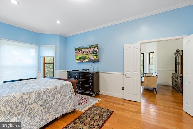 bedroom with light wood-type flooring and ornamental molding