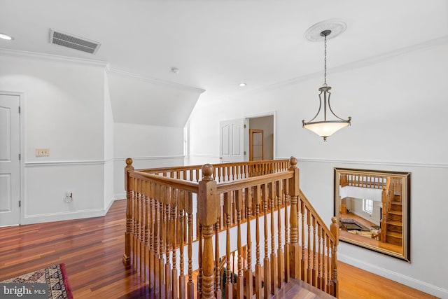 hall with hardwood / wood-style flooring and crown molding