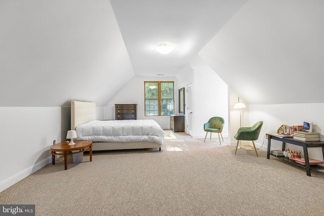 carpeted bedroom featuring lofted ceiling