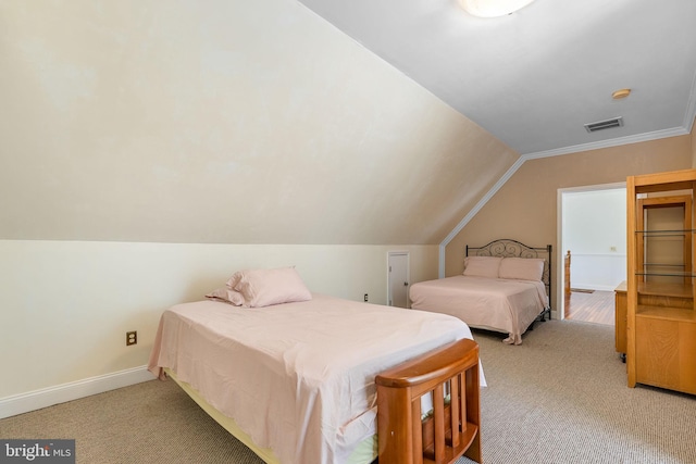 carpeted bedroom with lofted ceiling and ornamental molding