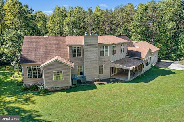 rear view of house with a yard, a patio, and central air condition unit