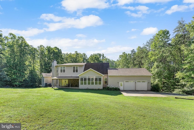 view of front of property with a garage and a front lawn