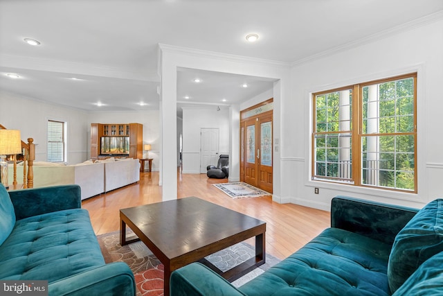 living room featuring french doors, light hardwood / wood-style floors, and crown molding