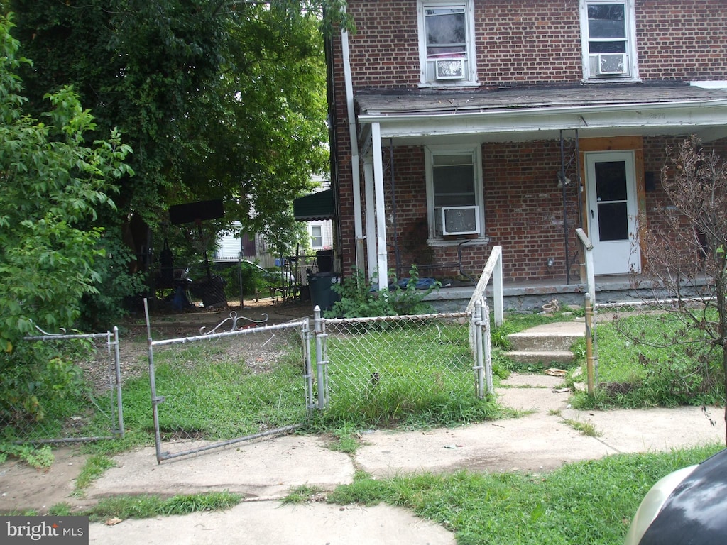 view of side of home featuring covered porch